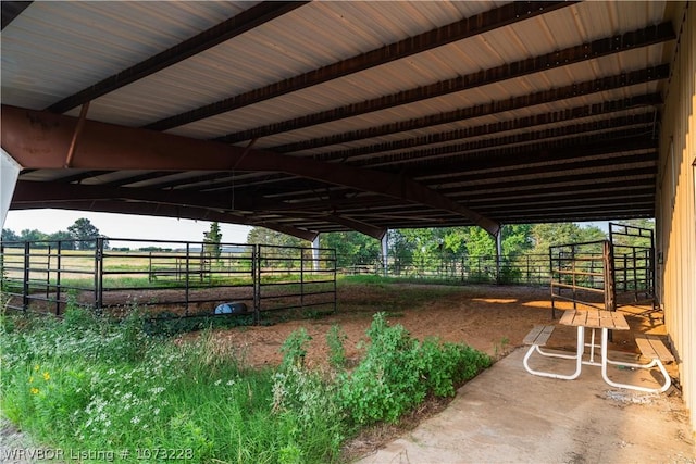 view of horse barn with a rural view