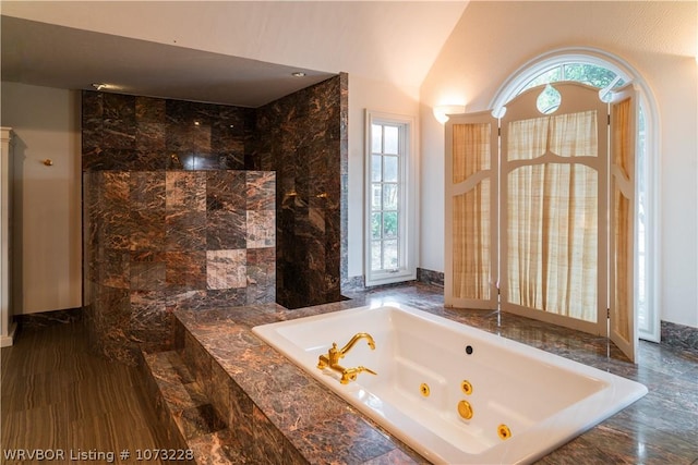 bathroom with tiled tub