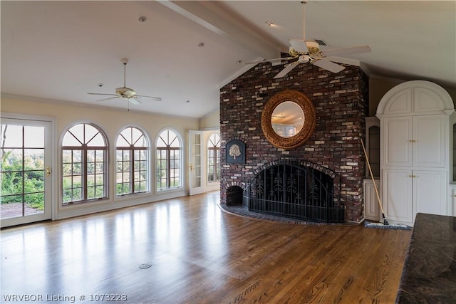 unfurnished living room with vaulted ceiling with beams, ceiling fan, a fireplace, and light hardwood / wood-style flooring