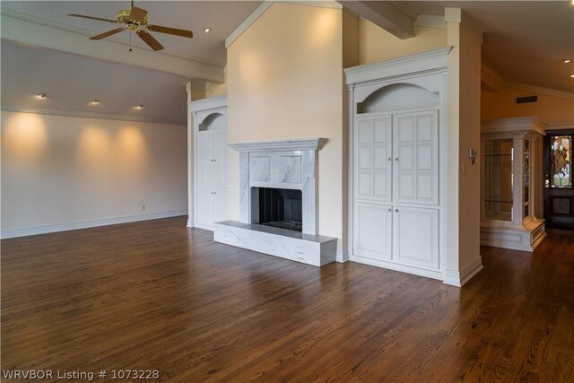 unfurnished living room with crown molding, vaulted ceiling with beams, ceiling fan, dark hardwood / wood-style floors, and a premium fireplace