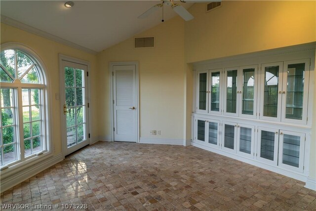 unfurnished sunroom featuring ceiling fan and lofted ceiling