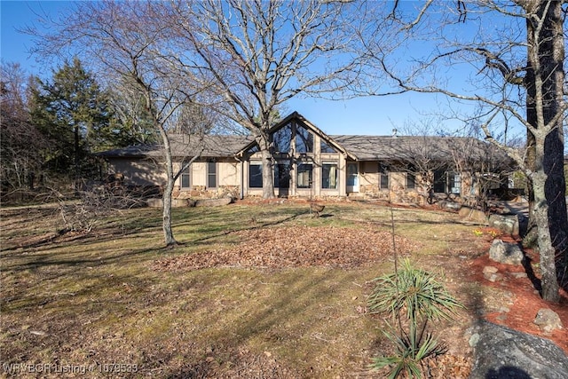 view of front of property with a front yard and stucco siding