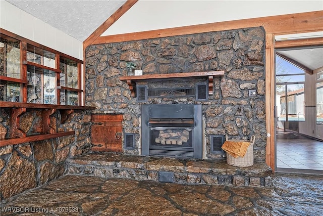 details featuring visible vents, a textured ceiling, and a fireplace