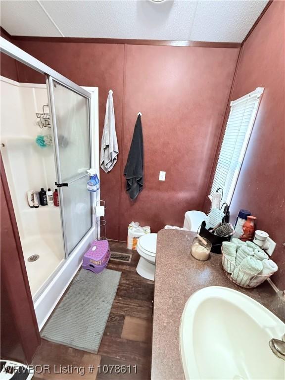 205 Lee Ordner, Panama, OK 74951 - full bath featuring a shower stall, wood finished floors, toilet, and a sink