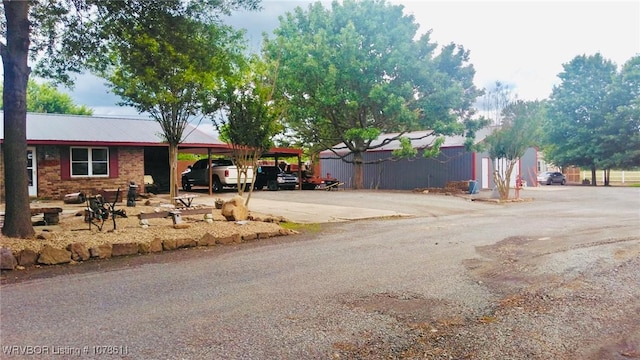 205 Lee Ordner, Panama, OK 74951 - exterior space featuring an attached carport, concrete driveway, and metal roof