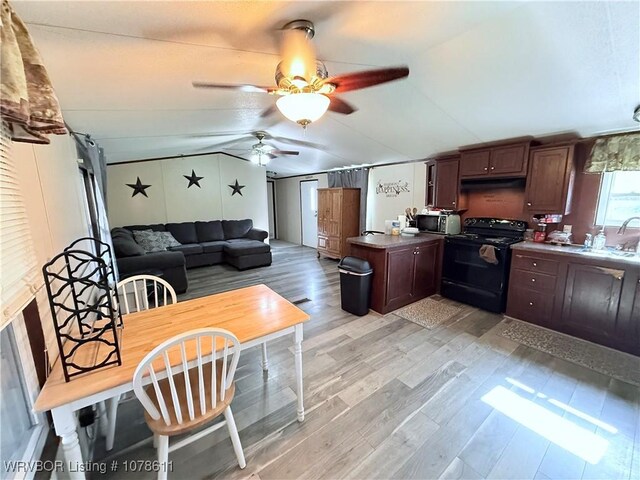 205 Lee Ordner, Panama, OK 74951 - kitchen with black electric range, a sink, light wood-style floors, lofted ceiling, and ceiling fan