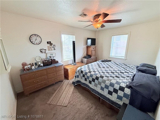 205 Lee Ordner, Panama, OK 74951 - bedroom featuring dark colored carpet, visible vents, a textured ceiling, and a ceiling fan