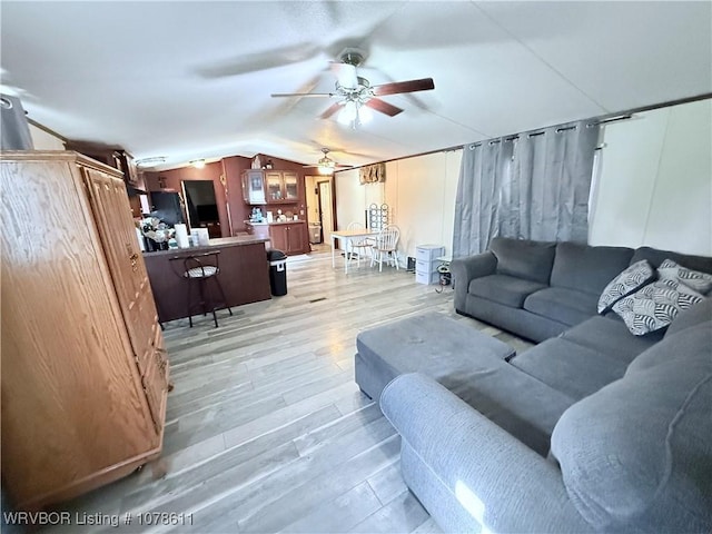 205 Lee Ordner, Panama, OK 74951 - living room featuring light wood finished floors, ceiling fan, and vaulted ceiling