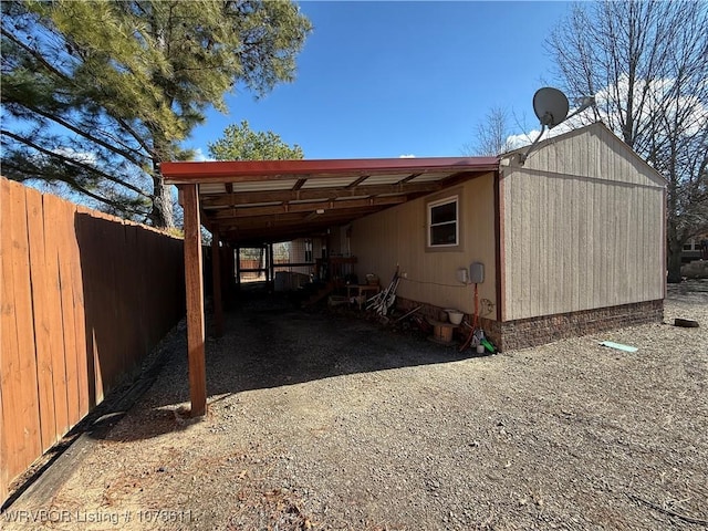 205 Lee Ordner, Panama, OK 74951 - view of outbuilding with a carport, fence, and dirt driveway