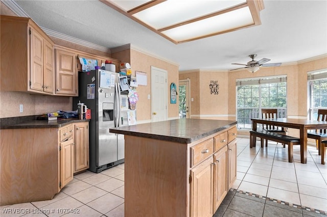 kitchen featuring stainless steel fridge, ceiling fan, a kitchen island, and light tile patterned flooring