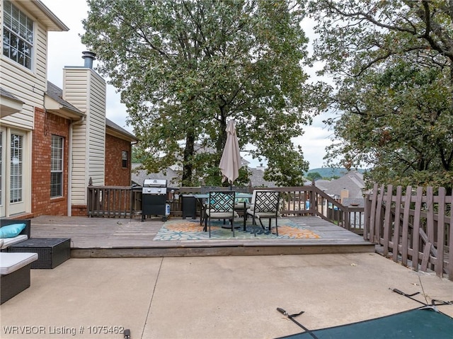 view of patio with grilling area and a wooden deck