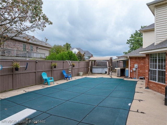 view of pool with a patio and a hot tub