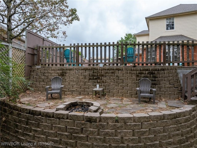 view of patio featuring an outdoor fire pit and a wooden deck