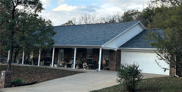 view of front facade featuring covered porch and a garage