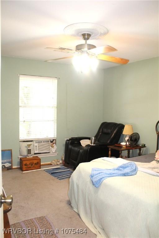 bedroom with ceiling fan and carpet