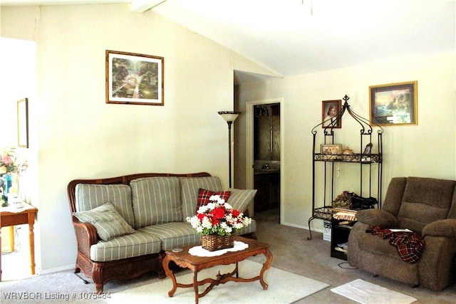 living room featuring lofted ceiling with beams and light colored carpet