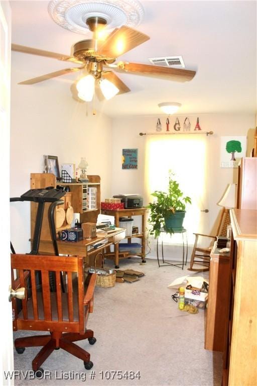 home office with ceiling fan and carpet