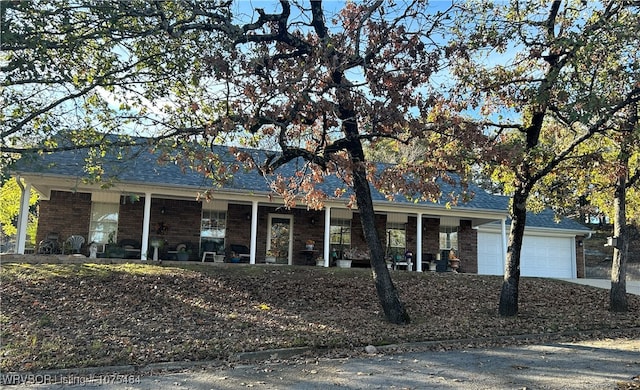 ranch-style house featuring a porch and a garage