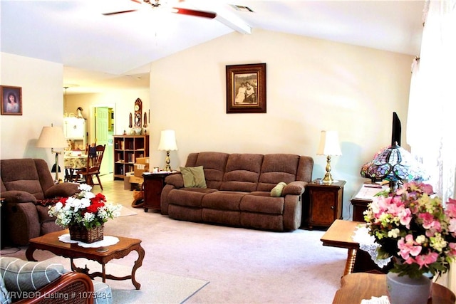 carpeted living room with ceiling fan and lofted ceiling with beams