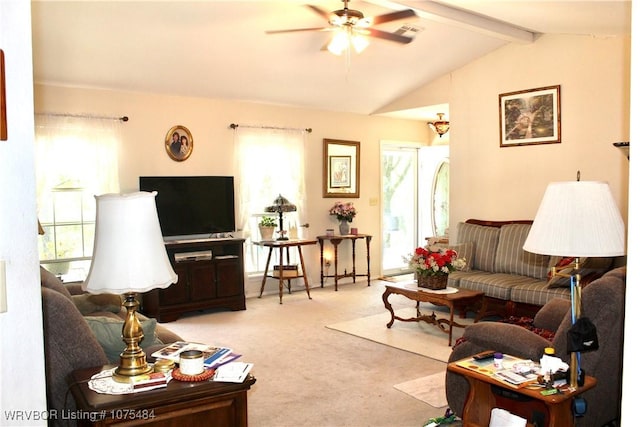 carpeted living room with lofted ceiling with beams, plenty of natural light, and ceiling fan