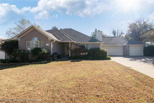 ranch-style home featuring a front yard and a garage