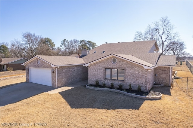 ranch-style house featuring a garage and central AC unit