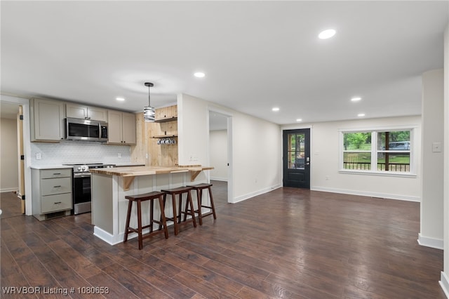 kitchen featuring gray cabinets, open shelves, stainless steel appliances, recessed lighting, and dark wood-type flooring