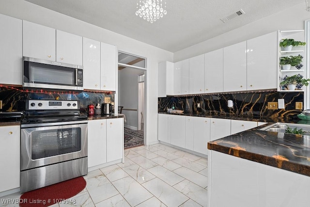 6408 Southfield Dr, Fort Smith, AR 72916 - kitchen with stainless steel appliances, marble finish floor, a sink, dark countertops, and visible vents