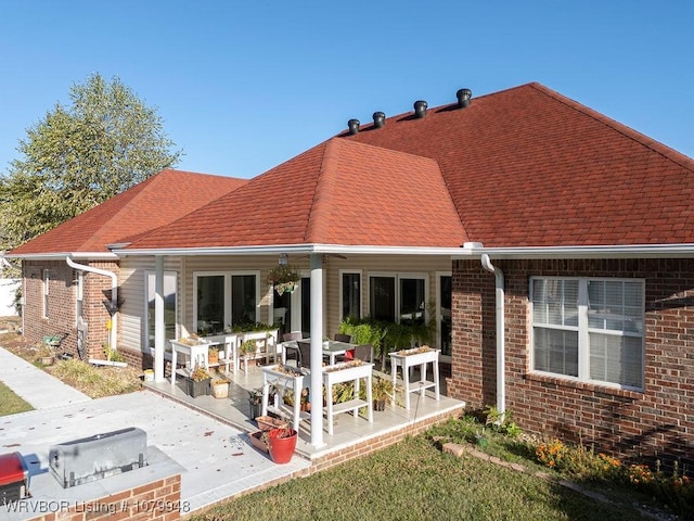 6408 Southfield Dr, Fort Smith, AR 72916 - back of house featuring brick siding, roof with shingles, and a patio area