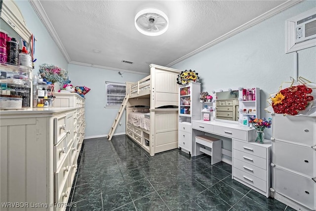 bedroom featuring visible vents, a textured ceiling, a wall unit AC, crown molding, and baseboards