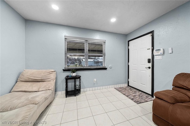 foyer with tile patterned floors, baseboards, and recessed lighting