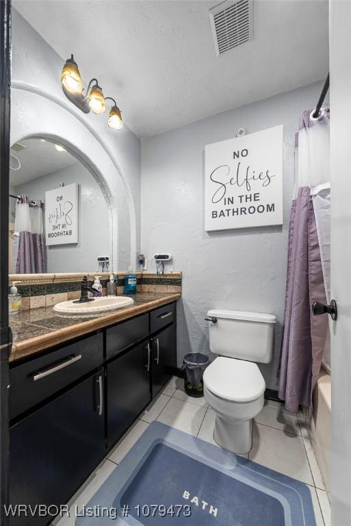 full bathroom featuring tile patterned floors, visible vents, toilet, and vanity