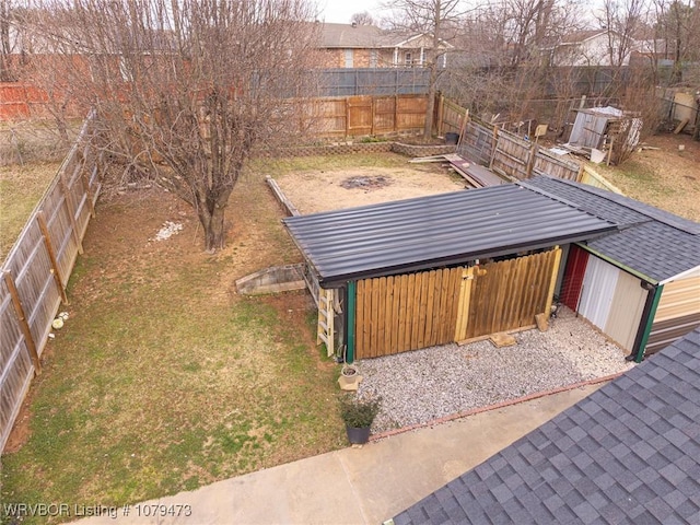 view of yard featuring an outbuilding and a fenced backyard