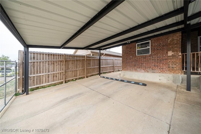 view of patio / terrace featuring a carport and fence