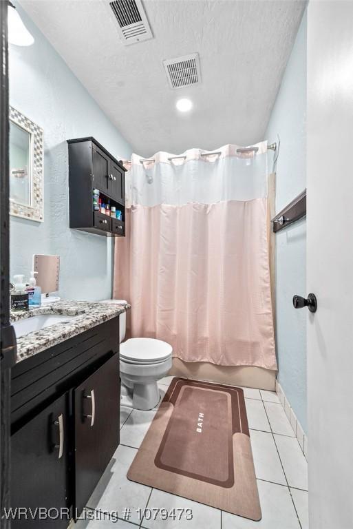 bathroom featuring visible vents, toilet, shower / tub combo, tile patterned floors, and vanity