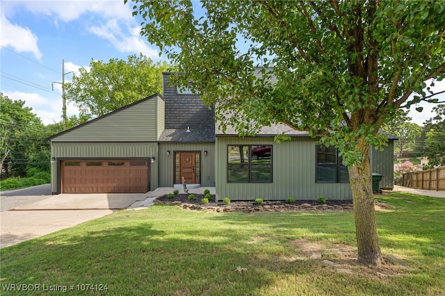 view of front of home with a garage and a front lawn