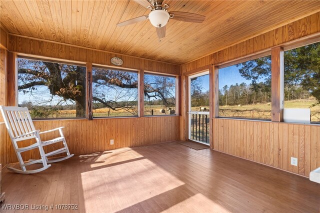 unfurnished sunroom featuring wooden ceiling and ceiling fan