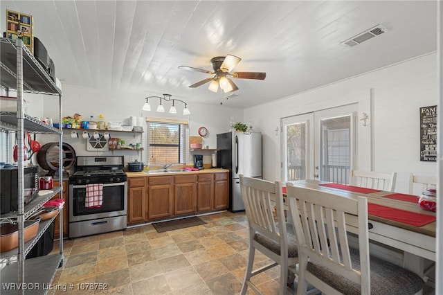 kitchen with sink, stainless steel appliances, wooden ceiling, and ceiling fan