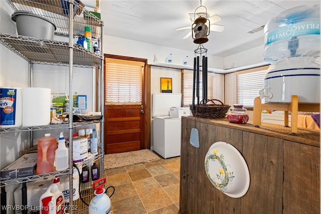 kitchen featuring washer / dryer and ceiling fan