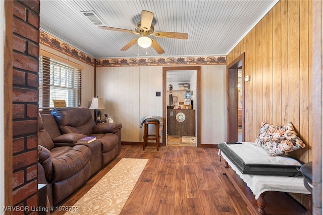 living room featuring wood-type flooring and ceiling fan