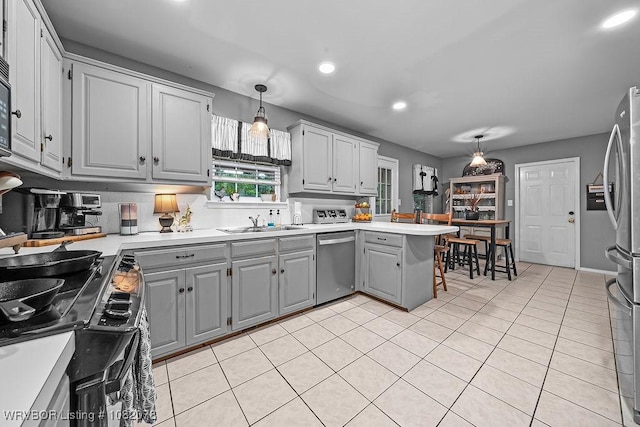 1804 Weeks Ln, Fort Smith, AR 72903 - kitchen with gray cabinetry, stainless steel appliances, light countertops, a peninsula, and recessed lighting