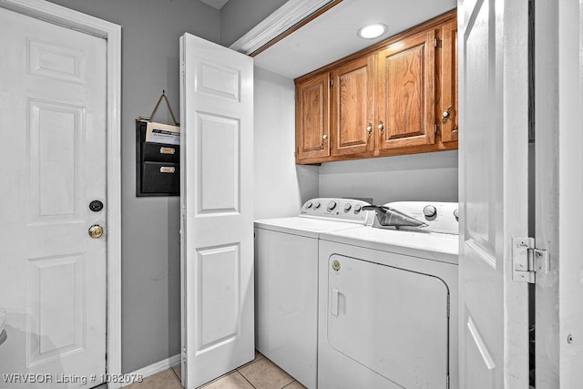 1804 Weeks Ln, Fort Smith, AR 72903 - laundry room with independent washer and dryer, cabinet space, and light tile patterned floors