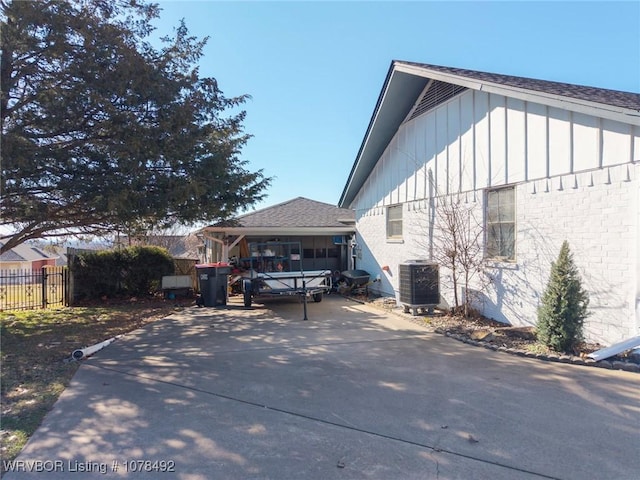 view of side of home with central AC unit