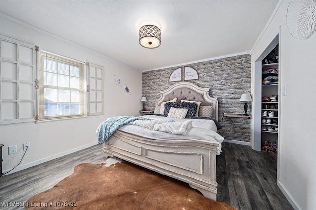 bedroom with dark wood-type flooring and crown molding