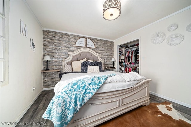 bedroom featuring a closet, dark hardwood / wood-style flooring, and ornamental molding