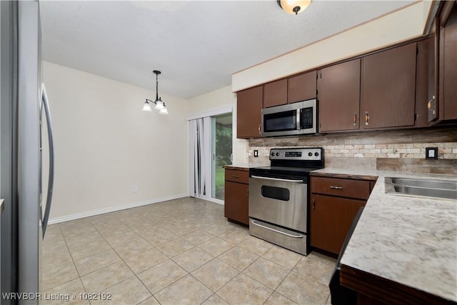 105 N Circle B, Roland, OK 74954 - kitchen featuring stainless steel appliances, backsplash, a chandelier, dark brown cabinets, and light tile patterned floors