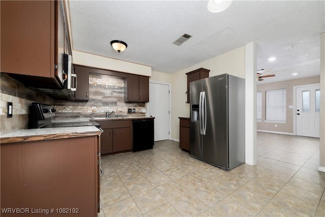 105 N Circle B, Roland, OK 74954 - kitchen featuring stainless steel fridge with ice dispenser, dishwasher, decorative backsplash, light tile patterned floors, and a textured ceiling