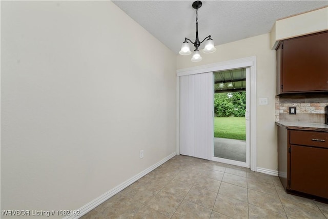 105 N Circle B, Roland, OK 74954 - unfurnished dining area featuring a chandelier, light tile patterned floors, and a textured ceiling