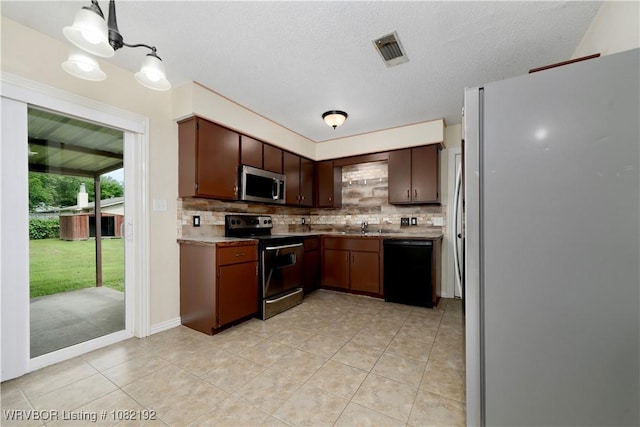 105 N Circle B, Roland, OK 74954 - kitchen featuring appliances with stainless steel finishes, backsplash, light tile patterned floors, light countertops, and a textured ceiling