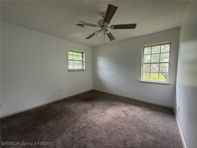 403 Woodland Hills Blvd, Roland, OK 74954 - carpeted empty room featuring a ceiling fan and a textured ceiling